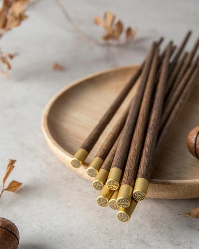 Chopsticks of real wood with a gold finish at the end
