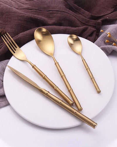 A flatware cutlery set of two spoons, one fork and one knife in gold 