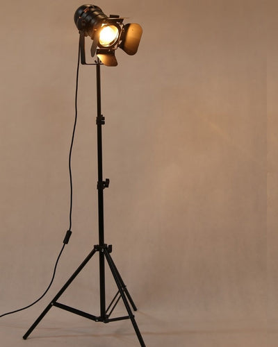 A camera flood light on a tripod on beige background