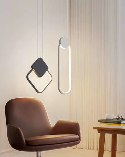 Ceiling lights in a modern geometrical design hanging in a living room over a brown chair