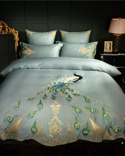 Marrakesh bedding in mint green covering a bed in front of a grey wall with a golden mirror next to the bed